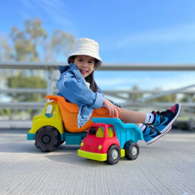 Girl sitting in toy truck.