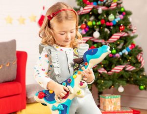 Girl playing toy guitar.