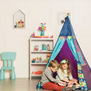 A boy and a girl in an indoor tent.