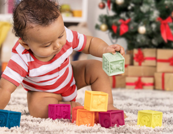 Baby playing with colorful blocks.