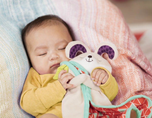 Baby sleeping with a security blanket.