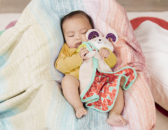Sleeping baby with security blanket.