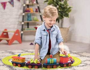 Smiling boy with train set.