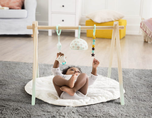 Baby in play gym.