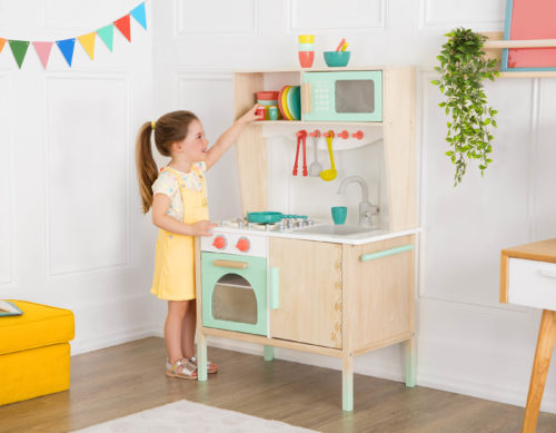Girl with play kitchen.