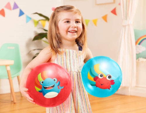 Smiling girl with two bouncy balls.