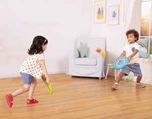 Boy and girl playing a paddle game.