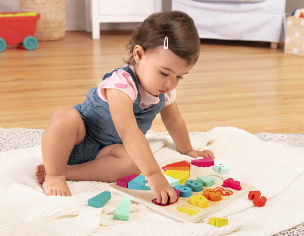 Girl playing with a colorful number puzzle.