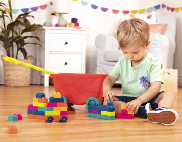 Boy playing with colorful building blocks.