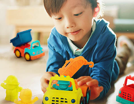 Boy with toy trucks.
