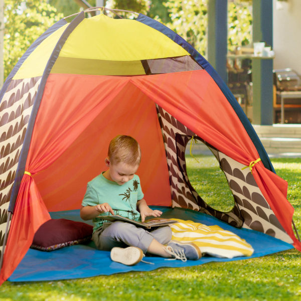 Boy reading in a play tent.
