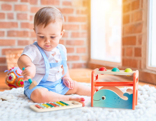 Baby with wooden toys.