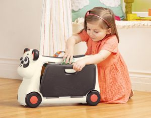 Girl with ride-on suitcase.