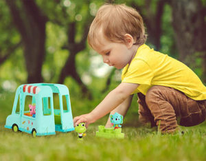 Boy playing with toy truck outside.